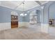 Elegant dining room features coffered ceilings, archways, and a view into kitchen and fireplace at 825 Bufflehead Ct, Stockbridge, GA 30281