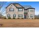Charming two-story brick home featuring manicured landscaping and a classic architectural design at 825 Bufflehead Ct, Stockbridge, GA 30281