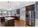 Bright kitchen with island, granite counters, stainless appliances, and hardwood floors at 825 Bufflehead Ct, Stockbridge, GA 30281