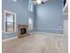 Cozy living room boasts a stone fireplace, soaring ceilings, and large windows for ample natural light at 825 Bufflehead Ct, Stockbridge, GA 30281