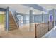 Open loft area with elegant staircase, wrought iron railing, and lots of natural light at 825 Bufflehead Ct, Stockbridge, GA 30281