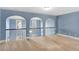 Open loft area with decorative archways, wrought iron railing, and lots of natural light at 825 Bufflehead Ct, Stockbridge, GA 30281