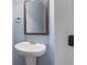 Charming powder room featuring a pedestal sink, mirror, and fresh paint at 825 Bufflehead Ct, Stockbridge, GA 30281
