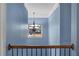 Elegant staircase with wrought iron railing and chandelier at 825 Bufflehead Ct, Stockbridge, GA 30281