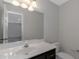 Well-lit bathroom featuring a vanity with a white countertop and a modern mirror at 880 Streamside Dr, Mcdonough, GA 30252