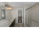 Bathroom with double vanity, shower with sliding door, and entry door at 880 Streamside Dr, Mcdonough, GA 30252