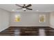 Bedroom showcasing dark hardwood floors, recessed lighting, and windows overlooking outside greenery at 880 Streamside Dr, Mcdonough, GA 30252