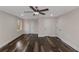 Large bedroom with sleek floors, ceiling fan, and several doors at 880 Streamside Dr, Mcdonough, GA 30252