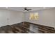 Bright bedroom features sleek dark floors, neutral walls, ceiling fan and a door to a large walk-in closet at 880 Streamside Dr, Mcdonough, GA 30252
