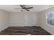 Bedroom features dark hardwood floors, recessed lighting, ceiling fan, a window and two doors at 880 Streamside Dr, Mcdonough, GA 30252