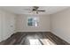 Bright, inviting bedroom with ceiling fan, window with outdoor views, and a door at 880 Streamside Dr, Mcdonough, GA 30252