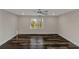 Spacious bedroom featuring sleek dark floors, neutral walls, and a large window at 880 Streamside Dr, Mcdonough, GA 30252