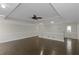 Open living room with dark wood floors, tray ceiling, and decorative trim at 880 Streamside Dr, Mcdonough, GA 30252