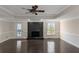 Inviting living room with a fireplace, hardwood floors, a ceiling fan, and direct access to a deck or patio at 880 Streamside Dr, Mcdonough, GA 30252