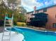 Inviting in-ground pool with a slide, surrounded by a well-maintained backyard at 880 Streamside Dr, Mcdonough, GA 30252