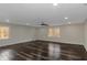 Expansive room featuring ample natural light, ceiling fan, and stylish wide plank flooring at 880 Streamside Dr, Mcdonough, GA 30252