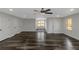 Spacious room featuring ample natural light, ceiling fan, and stylish wide plank flooring at 880 Streamside Dr, Mcdonough, GA 30252