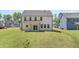 Expansive backyard featuring a lush lawn and a covered porch, perfect for outdoor relaxation at 14 Ramble Way, Sharpsburg, GA 30277