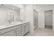 Modern bathroom with double vanity, granite countertops, and a glass-enclosed shower at 14 Ramble Way, Sharpsburg, GA 30277