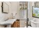 Charming bathroom with pedestal sink, vintage vanity, and natural light from the window at 2 W Muscogee Nw Ave, Atlanta, GA 30305