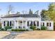 Charming white home featuring a classic facade with black shutters and a well-maintained front lawn at 2 W Muscogee Nw Ave, Atlanta, GA 30305