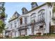 A picturesque, white, multi-story home with a curved facade and ample windows at 2 W Muscogee Nw Ave, Atlanta, GA 30305