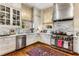 Elegant kitchen featuring white cabinets, marble countertops, stainless steel appliances, and a vintage rug at 2 W Muscogee Nw Ave, Atlanta, GA 30305
