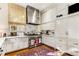 Bright kitchen showcasing white cabinetry, marble backsplash, stainless steel range, and a charming accent rug at 2 W Muscogee Nw Ave, Atlanta, GA 30305
