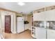 Functional kitchen with stainless steel countertops, white cabinetry, and a built-in dishwasher at 2 W Muscogee Nw Ave, Atlanta, GA 30305