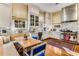 Bright, eat-in kitchen with white cabinetry, marble countertops, stainless steel appliances, and hardwood floors at 2 W Muscogee Nw Ave, Atlanta, GA 30305