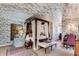 Comfortable main bedroom showcasing a four-poster bed, patterned walls, and a decorative screen at 2 W Muscogee Nw Ave, Atlanta, GA 30305