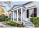 Close-up of the columned front porch, showcasing detailed iron railings and manicured landscaping at 2 W Muscogee Nw Ave, Atlanta, GA 30305