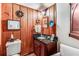 Cozy powder room featuring dark wood paneling, granite vanity, and classic fixtures at 2 W Muscogee Nw Ave, Atlanta, GA 30305