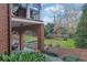 Beautiful backyard featuring lush greenery, arched brick accents, and well-maintained landscaping at 4084 Peachtree Dunwoody Ne Rd, Atlanta, GA 30342