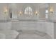 Bright bathroom offers granite countertops, white cabinets, and decorative mirrors at 4084 Peachtree Dunwoody Ne Rd, Atlanta, GA 30342