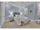 Relaxing bedroom features soft blue walls, with a bench at the foot of the bed at 4084 Peachtree Dunwoody Ne Rd, Atlanta, GA 30342