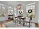 Dining room with large windows, hardwood floors, and stylish chandelier for entertaining at 4084 Peachtree Dunwoody Ne Rd, Atlanta, GA 30342