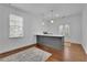 Dining room with wood floors and an island with a sink and dishwasher at 4084 Peachtree Dunwoody Ne Rd, Atlanta, GA 30342