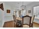 Inviting dining room with stylish chandelier, classic moldings, and hardwood floors at 4084 Peachtree Dunwoody Ne Rd, Atlanta, GA 30342