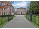Home entrance with gated access and a circular driveway leading to an elegant brick residence at 4084 Peachtree Dunwoody Ne Rd, Atlanta, GA 30342