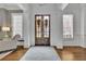 Welcoming foyer with double doors, hardwood floors, plantation shutters, and classic architectural details at 4084 Peachtree Dunwoody Ne Rd, Atlanta, GA 30342