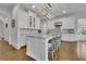 Bright, white kitchen with a large island, granite countertops, stainless steel appliances, and hardwood floors at 4084 Peachtree Dunwoody Ne Rd, Atlanta, GA 30342