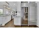 Gourmet kitchen featuring stainless steel appliances and a large wine fridge and hardwood floors at 4084 Peachtree Dunwoody Ne Rd, Atlanta, GA 30342