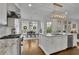 Bright, open kitchen with stainless steel appliances, granite countertops, and an adjacent dining area filled with natural light at 4084 Peachtree Dunwoody Ne Rd, Atlanta, GA 30342