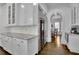 Well-appointed kitchen with custom cabinetry, a built-in wine fridge, and a seamless flow to the breakfast area at 4084 Peachtree Dunwoody Ne Rd, Atlanta, GA 30342