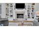 Cozy living room with a brick fireplace, custom built-in shelving, and comfortable seating arrangement at 4084 Peachtree Dunwoody Ne Rd, Atlanta, GA 30342