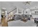 Spacious living area featuring hardwood floors, a staircase, and views into the kitchen at 4084 Peachtree Dunwoody Ne Rd, Atlanta, GA 30342