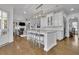 Open floor plan with kitchen island and seating with a view of the living room fireplace at 4084 Peachtree Dunwoody Ne Rd, Atlanta, GA 30342