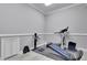 This workout room has a Total Gym exercise system, rubber floor and white cabinets at 4084 Peachtree Dunwoody Ne Rd, Atlanta, GA 30342