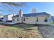 Rear exterior featuring a well-maintained yard, patio, neutral siding, windows and mature trees at 500 Allen'S Landing Ct, Lawrenceville, GA 30045